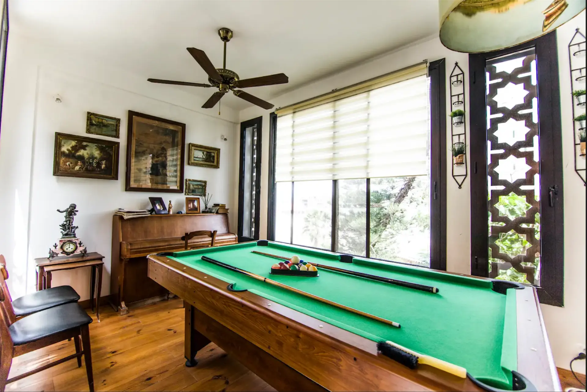 Games room with pool table, piano and framed art
